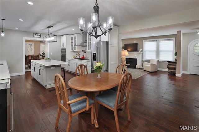 728 Yale Ave, Saint Louis, MO 63130 - dining area featuring a chandelier, recessed lighting, a fireplace, and dark wood-style floors