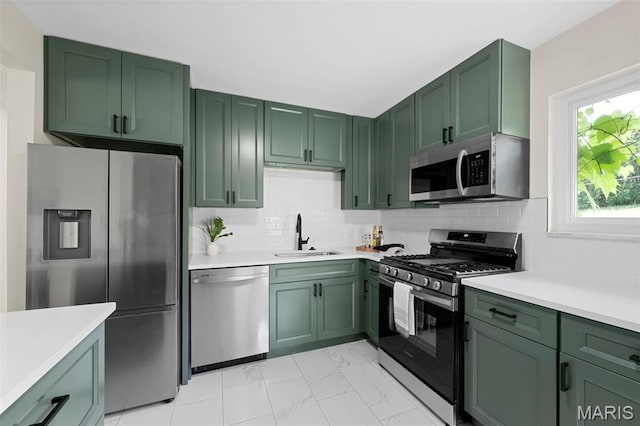 7944 Lavington Dr, Richmond Heights, MO 63117 - kitchen featuring appliances with stainless steel finishes, green cabinetry, light marble finish floors, and light countertops