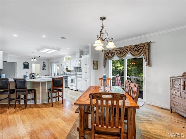 394 Sunset Echo Rd, Union, MO 63084 - dining room with a chandelier, light wood-style flooring, crown molding, and recessed lighting