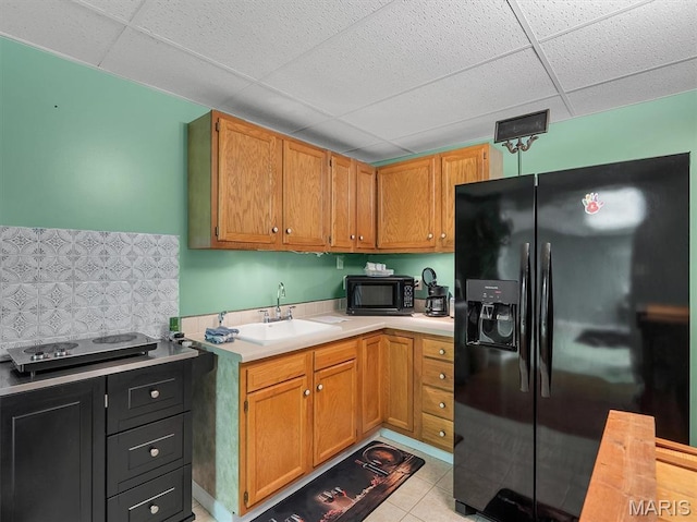 394 Sunset Echo Rd, Union, MO 63084 - kitchen featuring black appliances, a paneled ceiling, light countertops, backsplash, and light tile patterned flooring