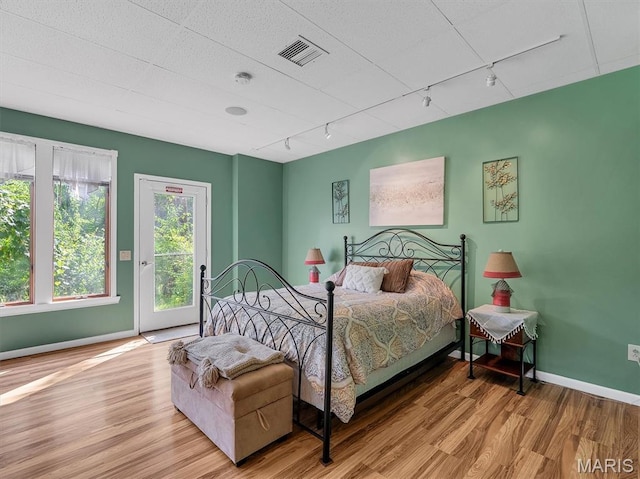 394 Sunset Echo Rd, Union, MO 63084 - bedroom featuring track lighting, wood finished floors, and access to outside