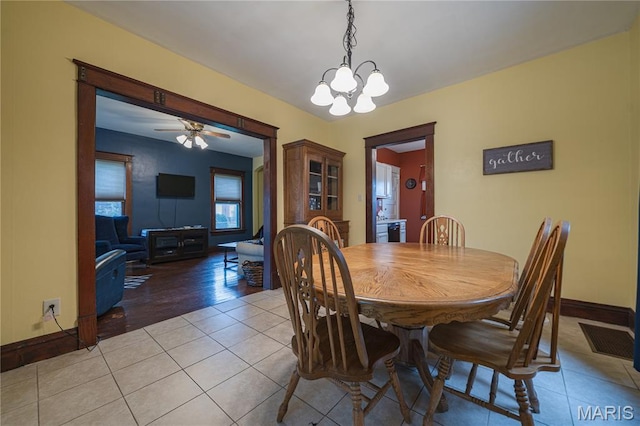 2324 Grand Ave, Granite City, IL 62040 - dining room featuring light tile patterned flooring, ceiling fan, and a chandelier