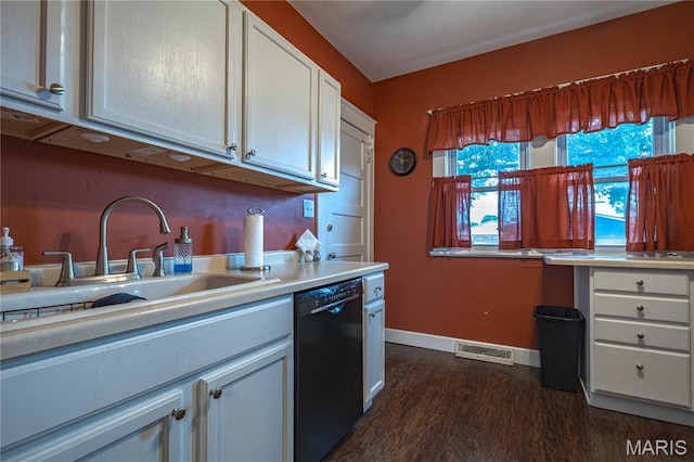 2324 Grand Ave, Granite City, IL 62040 - kitchen featuring black dishwasher, dark wood-style floors, light countertops, and white cabinets