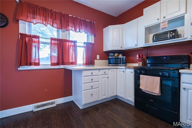 2324 Grand Ave, Granite City, IL 62040 - kitchen with black range with gas cooktop, dark wood-style floors, light countertops, and white cabinetry