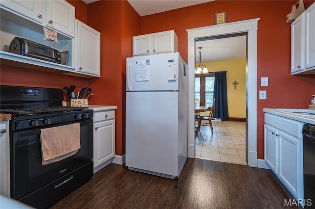2324 Grand Ave, Granite City, IL 62040 - kitchen with black appliances, a chandelier, white cabinetry, dark wood-style floors, and under cabinet range hood