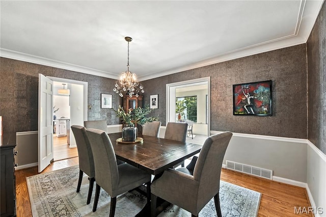 43 Highgate Rd, Olivette, MO 63132 - dining area featuring a chandelier, wood finished floors, and crown molding