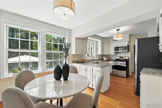 43 Highgate Rd, Olivette, MO 63132 - dining space featuring light wood finished floors