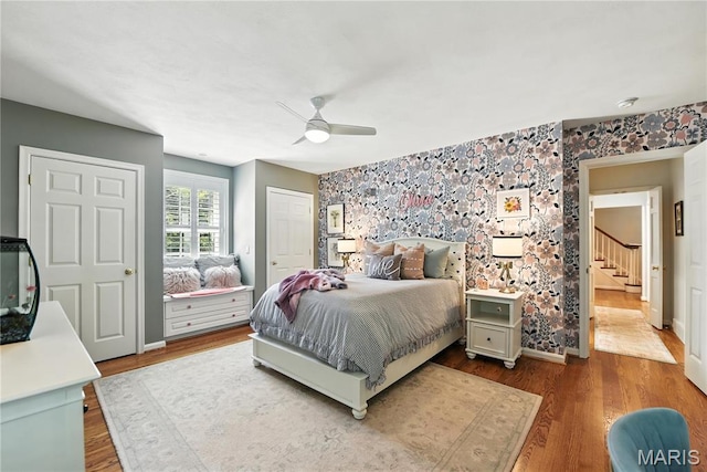 43 Highgate Rd, Olivette, MO 63132 - bedroom with wood finished floors, an accent wall, and a ceiling fan