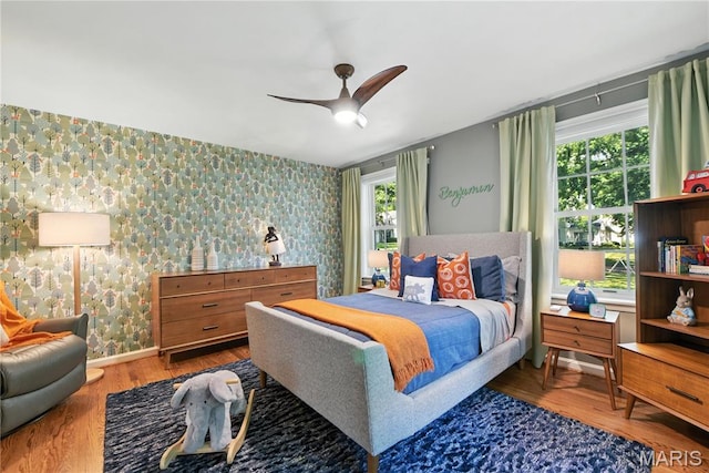 43 Highgate Rd, Olivette, MO 63132 - bedroom featuring wallpapered walls, multiple windows, wood finished floors, and a ceiling fan