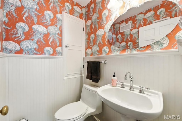 43 Highgate Rd, Olivette, MO 63132 - half bathroom featuring wallpapered walls and a wainscoted wall