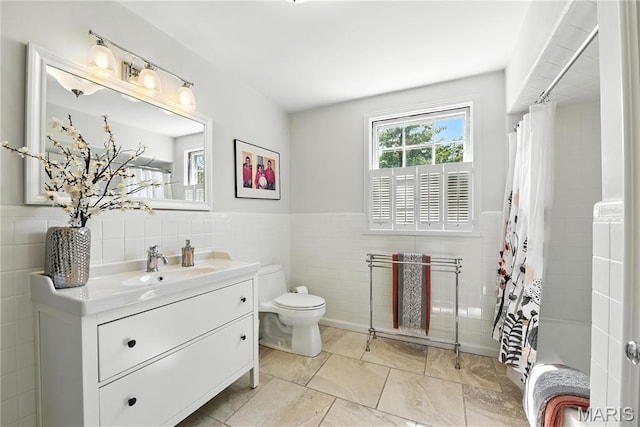 43 Highgate Rd, Olivette, MO 63132 - bathroom featuring tile walls, vanity, a wainscoted wall, and shower / bath combo