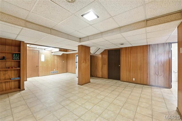 43 Highgate Rd, Olivette, MO 63132 - finished below grade area featuring a paneled ceiling, light floors, and wooden walls