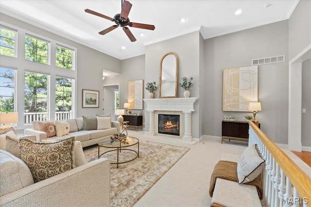 1931 Chesterfield Ridge Cir, Chesterfield, MO 63017 - living room featuring a towering ceiling, a glass covered fireplace, ceiling fan, ornamental molding, and recessed lighting