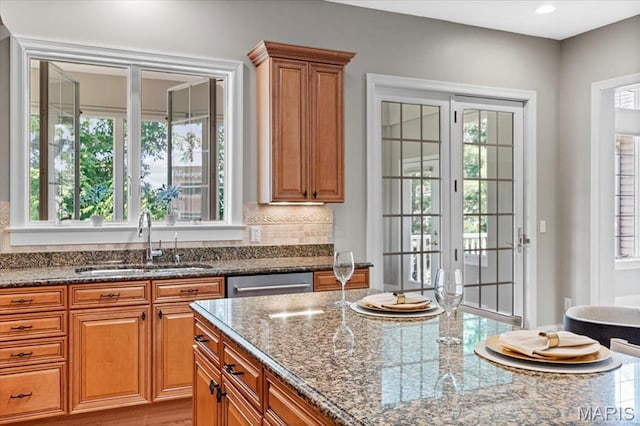 1931 Chesterfield Ridge Cir, Chesterfield, MO 63017 - kitchen featuring dark stone countertops, brown cabinetry, french doors, dishwasher, and recessed lighting