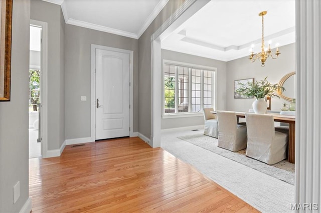 1931 Chesterfield Ridge Cir, Chesterfield, MO 63017 - foyer entrance featuring a chandelier, light wood-style flooring, healthy amount of natural light, and crown molding