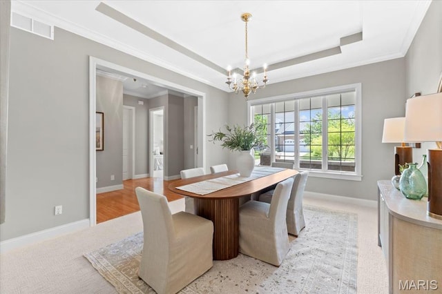 1931 Chesterfield Ridge Cir, Chesterfield, MO 63017 - dining room with a chandelier, a raised ceiling, crown molding, and carpet floors