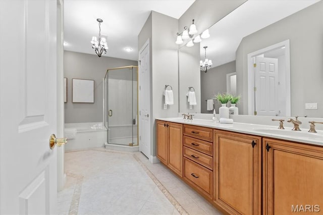 1931 Chesterfield Ridge Cir, Chesterfield, MO 63017 - bathroom featuring a chandelier, inlaid floor details, double vanity, a garden tub, and a stall shower