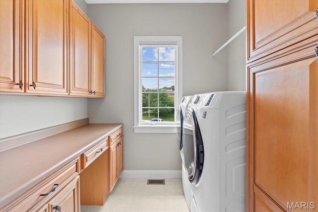 1931 Chesterfield Ridge Cir, Chesterfield, MO 63017 - washroom with independent washer and dryer, cabinet space, and light tile patterned floors