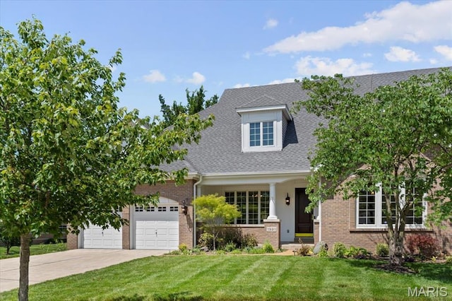 1931 Chesterfield Ridge Cir, Chesterfield, MO 63017 - new england style home with driveway, brick siding, a front lawn, a garage, and roof with shingles