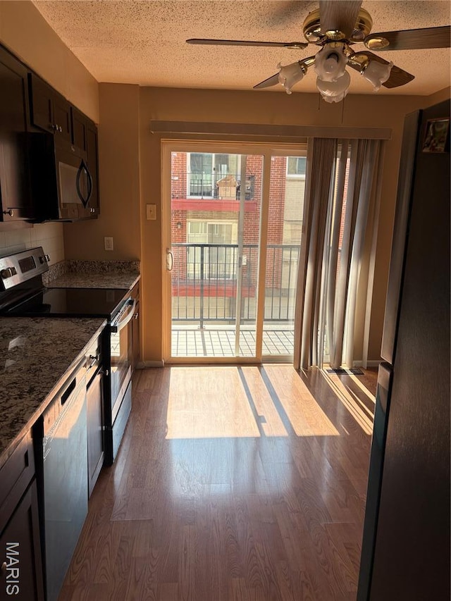 10335 Forest Brook Ln Unit C, Creve Coeur, MO 63146 - kitchen with appliances with stainless steel finishes, ceiling fan, dark wood-style floors, stone countertops, and a textured ceiling