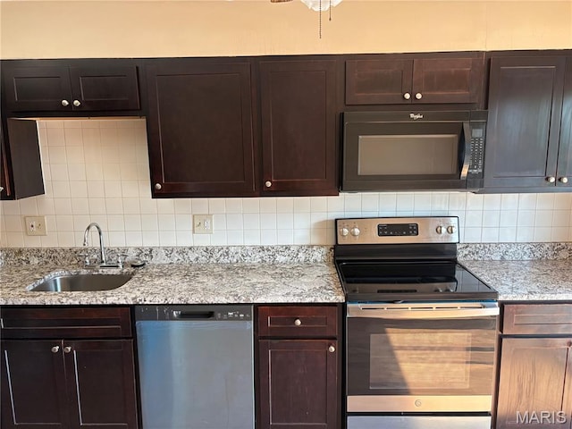 10335 Forest Brook Ln Unit C, Creve Coeur, MO 63146 - kitchen with appliances with stainless steel finishes, backsplash, dark brown cabinetry, and light stone counters