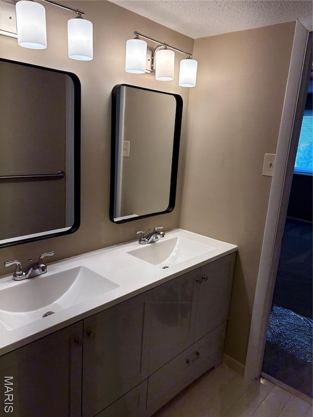 10335 Forest Brook Ln Unit C, Creve Coeur, MO 63146 - full bathroom with double vanity, a textured ceiling, and tile patterned floors