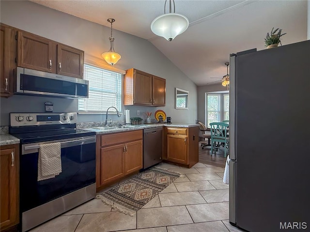 607 Apple Glen Ct, Arnold, MO 63010 - kitchen with stainless steel appliances, vaulted ceiling, ceiling fan, decorative light fixtures, and light countertops