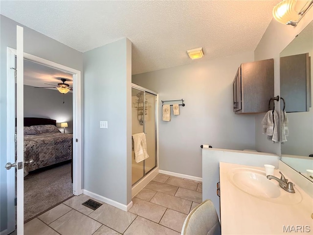 607 Apple Glen Ct, Arnold, MO 63010 - ensuite bathroom featuring a stall shower, vanity, tile patterned flooring, ceiling fan, and a textured ceiling
