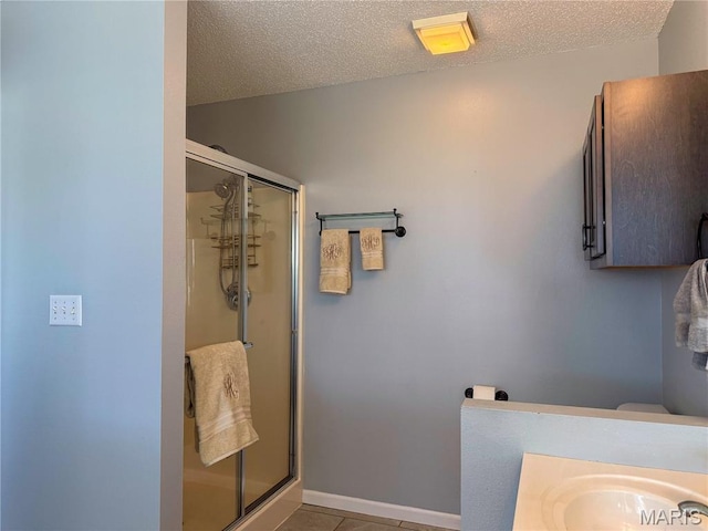607 Apple Glen Ct, Arnold, MO 63010 - bathroom featuring a shower stall, tile patterned flooring, and a textured ceiling