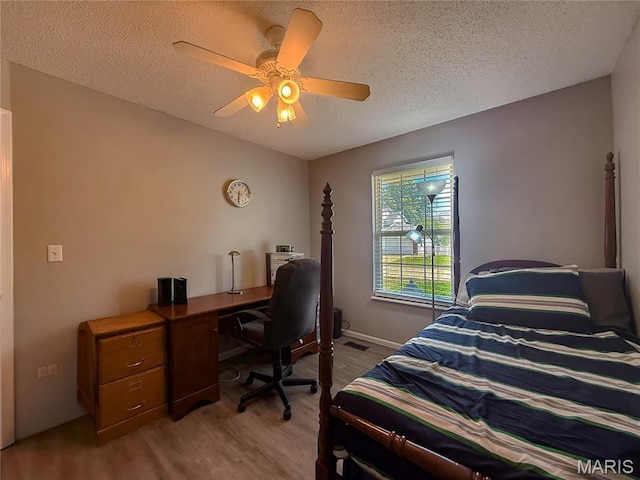 607 Apple Glen Ct, Arnold, MO 63010 - bedroom with light wood-style flooring, a textured ceiling, a ceiling fan, and an office area