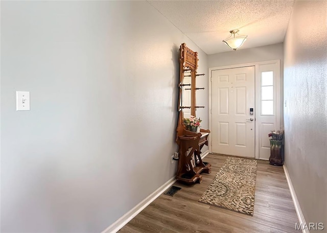 607 Apple Glen Ct, Arnold, MO 63010 - entrance foyer featuring wood finished floors and a textured ceiling