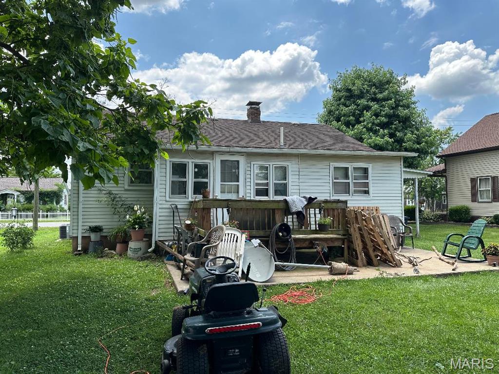 203 E Jenkins St, Steeleville, IL 62288 - back of house featuring a chimney and a lawn
