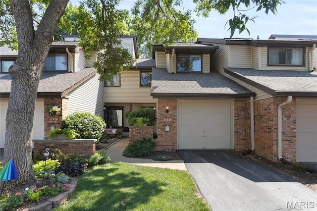 11724 Russet Meadow Dr, Creve Coeur Township, MO 63146 - townhome / multi-family property featuring a shingled roof, brick siding, asphalt driveway, and an attached garage