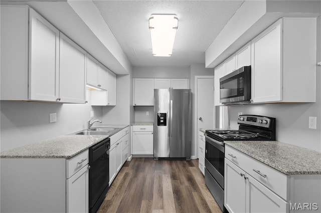 11724 Russet Meadow Dr, Creve Coeur Township, MO 63146 - kitchen featuring stainless steel appliances, white cabinetry, dark wood-style floors, light stone counters, and a textured ceiling