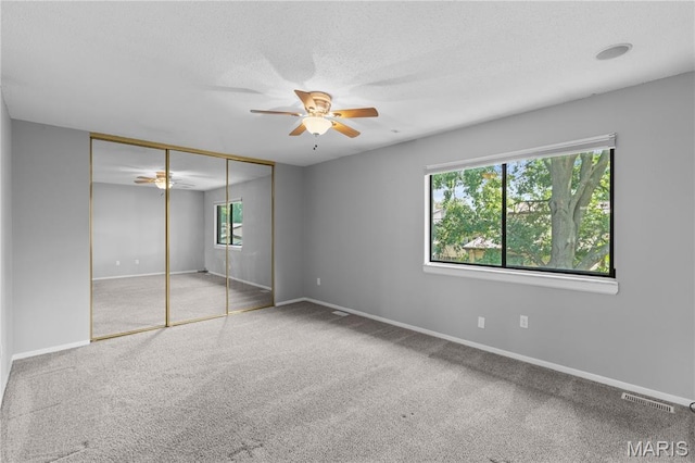 11724 Russet Meadow Dr, Creve Coeur Township, MO 63146 - unfurnished bedroom featuring carpet floors, a closet, a ceiling fan, and a textured ceiling