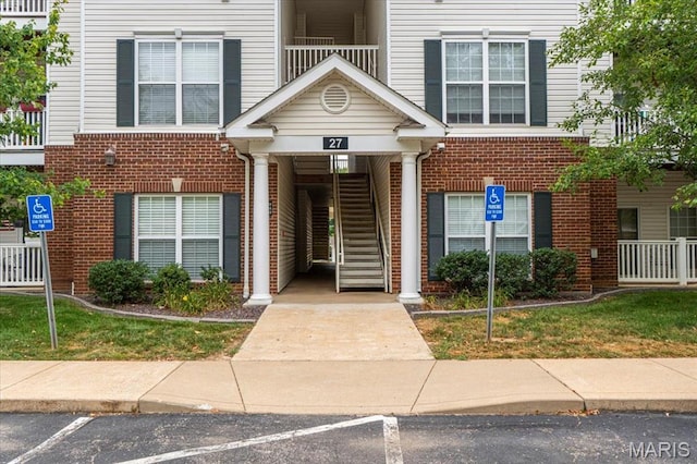 27 Kassebaum Ln Unit 302, Mehlville, MO 63129 - view of property with stairway and uncovered parking