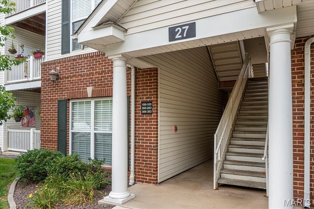 27 Kassebaum Ln Unit 302, Mehlville, MO 63129 - property entrance featuring brick siding and a balcony