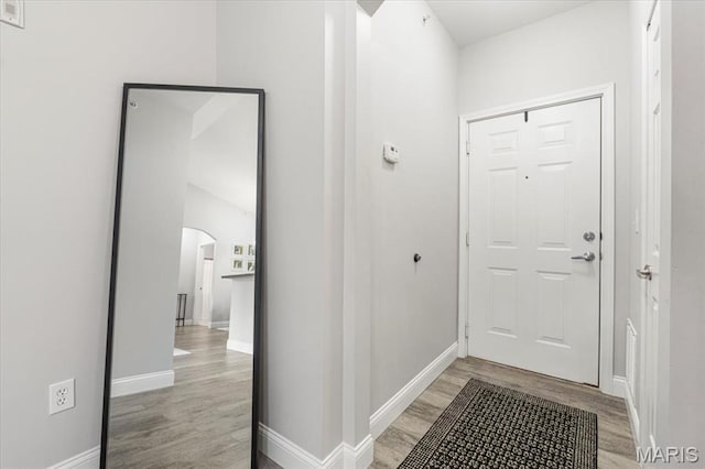27 Kassebaum Ln Unit 302, Mehlville, MO 63129 - doorway to outside with light wood-style floors and arched walkways