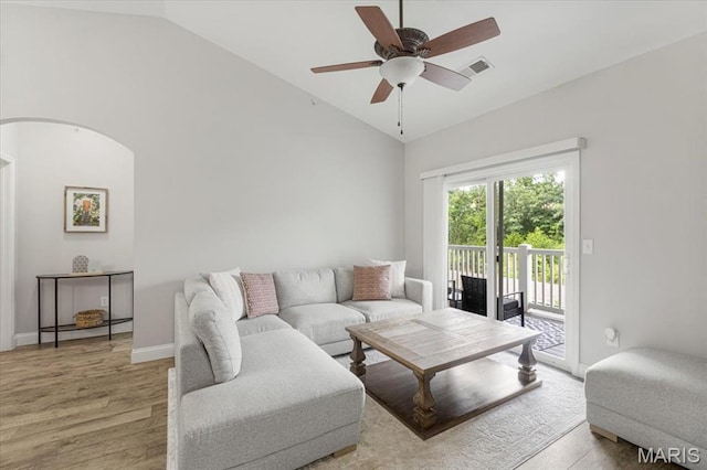 27 Kassebaum Ln Unit 302, Mehlville, MO 63129 - living room with lofted ceiling, a ceiling fan, light wood-style flooring, and arched walkways