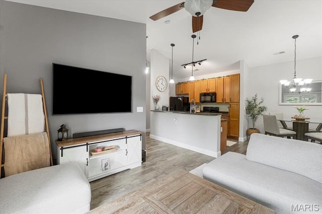 27 Kassebaum Ln Unit 302, Mehlville, MO 63129 - living area with light wood-style flooring, a chandelier, and ceiling fan