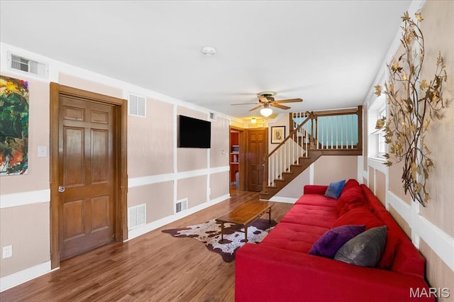 1239 Vero Ln, Ellisville, MO 63011 - living area featuring wood finished floors, ceiling fan, and stairs