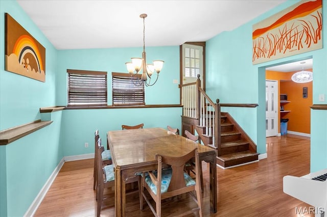 1239 Vero Ln, Ellisville, MO 63011 - dining area with a chandelier, wood finished floors, and stairway