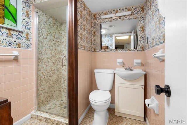 1239 Vero Ln, Ellisville, MO 63011 - full bathroom featuring tile walls, a shower stall, wallpapered walls, vanity, and a wainscoted wall