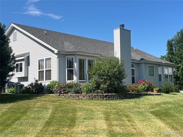 3 Boxwood Crest Ct, Ofallon, MO 63366 - rear view of house with a chimney, a lawn, and a shingled roof