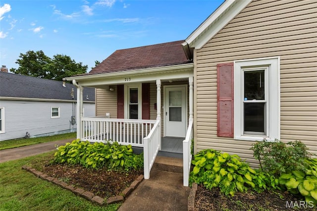 713 W Adams St, Jackson, MO 63755 - doorway to property featuring a porch and a shingled roof