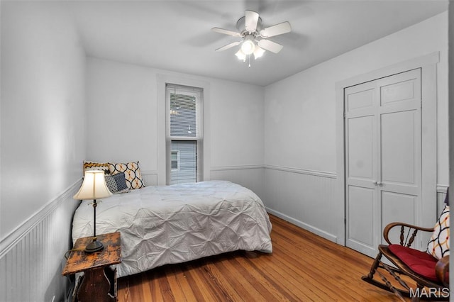 713 W Adams St, Jackson, MO 63755 - bedroom featuring wood finished floors, a wainscoted wall, and a ceiling fan