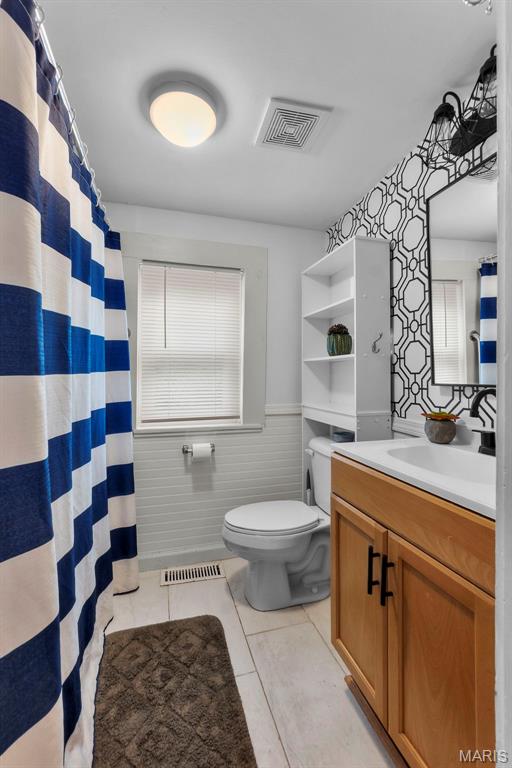 713 W Adams St, Jackson, MO 63755 - bathroom with vanity, a wainscoted wall, and tile patterned floors