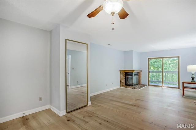12975 Bryce Canyon Dr Unit D, Maryland Heights, MO 63043 - unfurnished living room with light wood-style floors, ceiling fan, and a brick fireplace