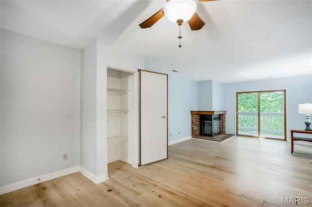 12975 Bryce Canyon Dr Unit D, Maryland Heights, MO 63043 - unfurnished living room with light wood finished floors, a fireplace, and a ceiling fan