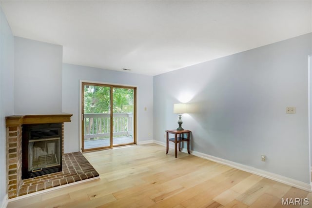 12975 Bryce Canyon Dr Unit D, Maryland Heights, MO 63043 - unfurnished living room featuring wood finished floors and a brick fireplace